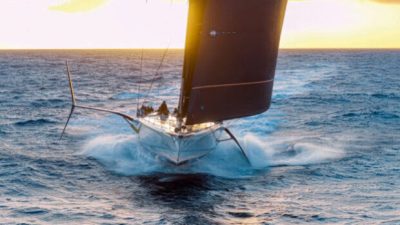 Crossing the Atlantic in under seven days on a foil-assisted