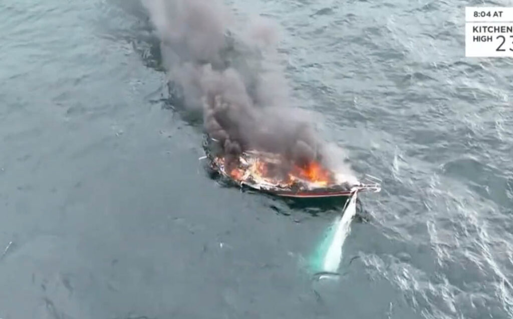 A video captures a boat fully engulfed in flames on