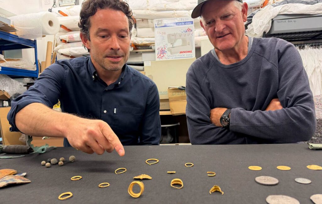 A collection of gold jewellery, silver coins and other artefacts