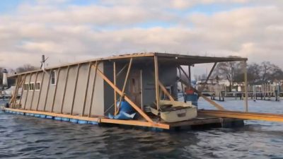A homemade houseboat cruising down the St. Clair River and