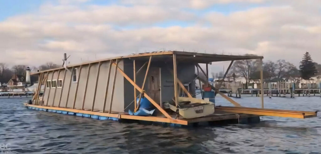 A homemade houseboat cruising down the St. Clair River and