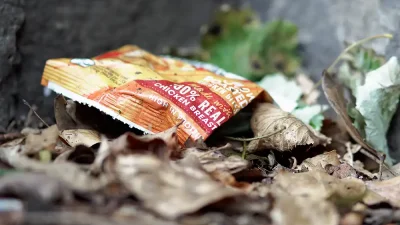 Discarded plastic food packaging, including crisp packets and sweet wrappers,