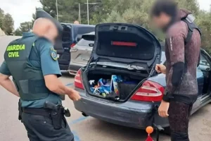The diver, still wearing his wetsuit as the Spanish Police